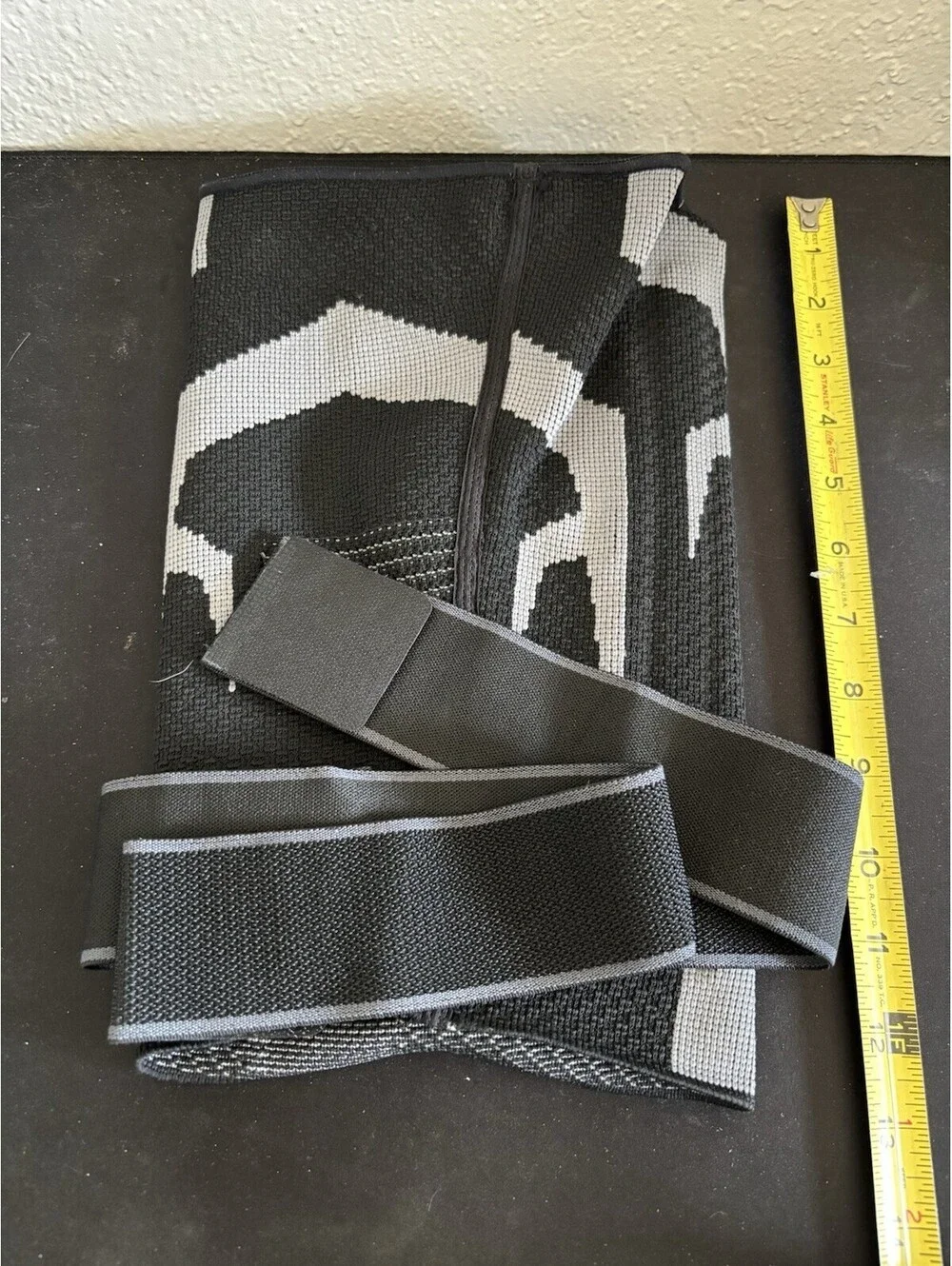 Anaconda brand knee brace featuring a black and gray textured design Size XL